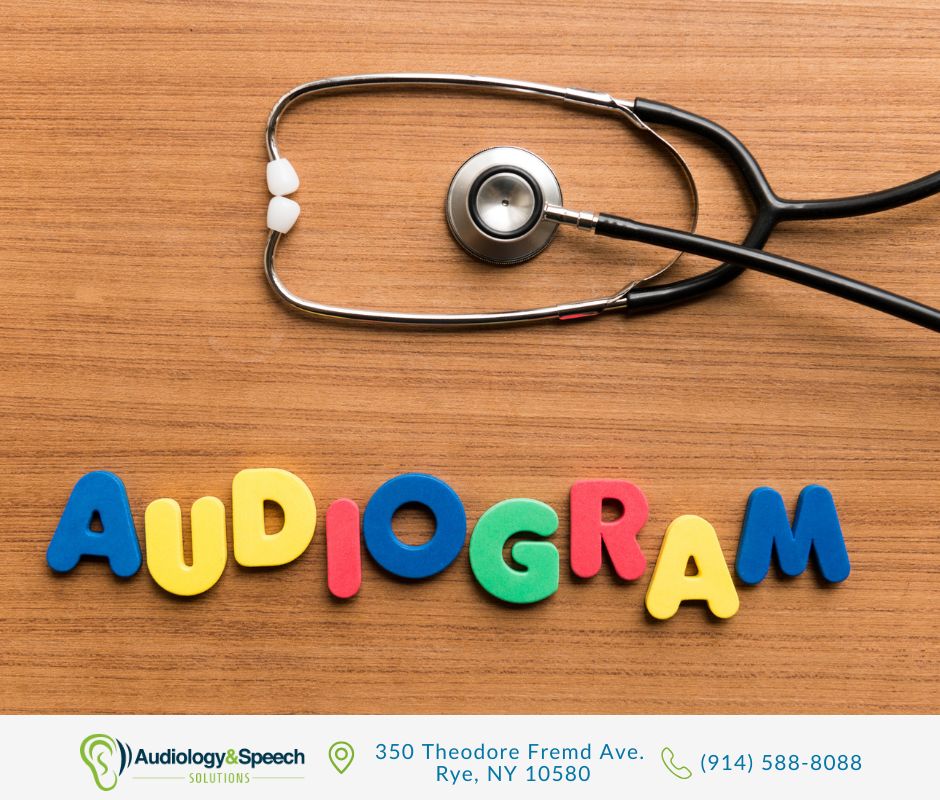 Stethoscope and colorful audiogram letters on a desk